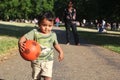 A Young Indian Toddler running with red ball Royalty Free Stock Photo
