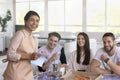 Indian waitress laughing with restaurant guests, group of young people Royalty Free Stock Photo