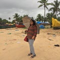 A young woman on the beach of Kundapura with an umbrella. Royalty Free Stock Photo