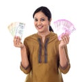 Young Indian woman holding currency notes agianst white Royalty Free Stock Photo