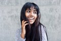 Young Indian woman laughing with hand in hair Royalty Free Stock Photo