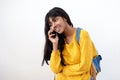 Young Indian woman laughing and talking with cellphone on isolated white background Royalty Free Stock Photo