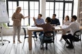 Young indian woman raising hand, asking questions to older speaker. Royalty Free Stock Photo