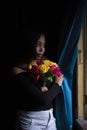 Young  Indian woman standing in front of a window/balcony Royalty Free Stock Photo