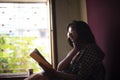 Young  Indian woman standing in front of a window/balcony Royalty Free Stock Photo