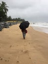 A young Indian woman strolling on the beach of Kundapura Royalty Free Stock Photo