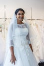 Young indian woman in wedding dress with bridal gowns on display Royalty Free Stock Photo