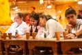 Young indian women sitting on the ground with low tables and eating a traditional rajasthani meal Royalty Free Stock Photo