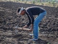Young indinan farmer digging in the field at latur, maharashtra