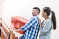 Young indonesian couple in stairway carrying removal crate