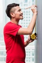 Young indonesian man sizing with tape measure