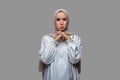 Young indonesian woman in hijab with sad, worried and disappointed expression
