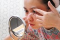 Young indonesian woman putting contact lens in her eye. Health And Eyes Care Concept Royalty Free Stock Photo