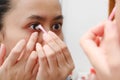 Young indonesian woman putting contact lens in her eye. Health And Eyes Care Concept Royalty Free Stock Photo