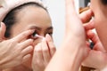 Young indonesian woman putting contact lens in her eye. Health And Eyes Care Concept Royalty Free Stock Photo