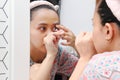 Young indonesian woman putting contact lens in her eye. Health And Eyes Care Concept Royalty Free Stock Photo