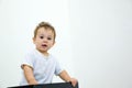 A young infant boy peeking out of a box on a white background Royalty Free Stock Photo