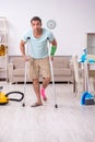 Young injured man cleaning the house