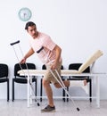 Young injured man waiting for his turn in hospital hall Royalty Free Stock Photo