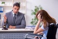 Young injured woman and male lawyer in the courtroom Royalty Free Stock Photo