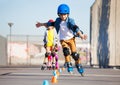 Young inline skater practicing forward slalom