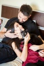 Young inlove couple on the bed with their cats