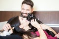 Young inlove couple on the bed with their cats