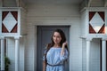 Young inscrutable woman stands at the entrance