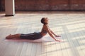 Young instructor doing yoga indoors