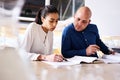 Young intelligent businesswoman showing latest progress to her male partner