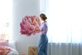 Young interior designer flower on wall in modern room