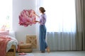 Young interior designer painting flower on wall in room