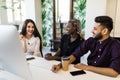 Young international business team working together on a creative idea, Young people discussing new business project in office Royalty Free Stock Photo