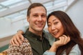 Young international couple taking selfie in the mall.