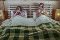 Internet addict couple on bed ignoring each other using social media app on mobile phone flirting and on line dating in relationsh