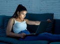 Young internet addicted woman working late at night on computer Royalty Free Stock Photo