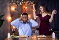 Young Interracial Couple Arguing During Dinner Date In Restaurant