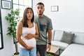 Young interracial couple expecting a baby, touching pregnant belly making fish face with lips, crazy and comical gesture Royalty Free Stock Photo