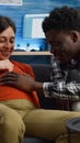Young interracial couple expecting child sitting on sofa Royalty Free Stock Photo