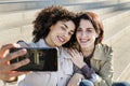 Young interracial couple of girls doing a selfie Royalty Free Stock Photo