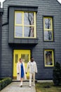 Young interracial couple holds each other hand and walks on street