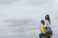 Young interracial couple hugging, laughing and kissing in a park Royalty Free Stock Photo