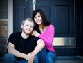 Young interracial couple sitting on front steps