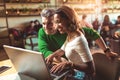 Young interracial couple spending time in cafe watching media Royalty Free Stock Photo