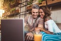 Young interracial couple spending time in cafe watching media Royalty Free Stock Photo