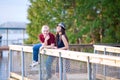 Young interracial couple standing together on wooden pier overlooking lake Royalty Free Stock Photo