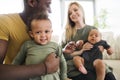 Young interracial family with little children at home. Royalty Free Stock Photo