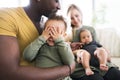 Young interracial family with little children at home. Royalty Free Stock Photo