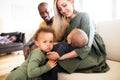 Young interracial family with little children at home. Royalty Free Stock Photo