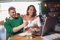 Young couple lovers spending time in cafe watching laptop Royalty Free Stock Photo